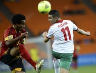 Morocco's midfielder Oussama Assaidi heads the ball despite of Angola's defender Lunguinha (L) on January 19, 2013